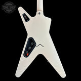 The back view of a white electric guitar with a distinctive angular body, black control plates, and a black pickup cover, shown against a solid black background. A 'TONE SHOP' watermark is visible in the top-left corner.