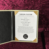 Gibson Custom Certificate of Authenticity on a maroon textured background