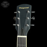 Close-up of a guitar headstock with the brand name 'Orangewood' in gold script on a black background. The headstock is black with six silver tuning pegs and strings, and a portion of the neck with a light wood fretboard is visible.