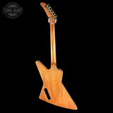 Wooden electric guitar on a black background with 'Tone Shop' logo.