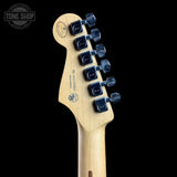 Close-up rear view of a guitar headstock with six black tuning pegs and visible 'SH' branding on a black background.