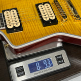 Gibson Explorer Dealer Select AAA Explorer Custom Lemon Burst on scale displaying weight.