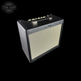 A Fuzz Face bass guitar amplifier with a black textured cabinet, cream-colored front grille, and a top handle, shown against a solid black background.