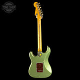 Green electric guitar with a black background