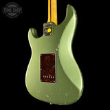 Green electric guitar with a visible brand logo on a black background