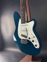 Blue electric guitar on a gray background