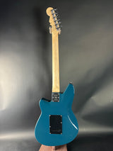 Blue electric guitar on a gray background