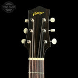 Close-up of the headstock of a Crowsay acoustic guitar against a black background, showing the brand name in gold script and six tuning pegs.