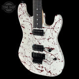 White electric guitar with red splatter design on a black background, featuring 'Tone Shop' logo.