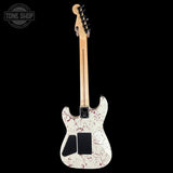 White electric guitar with red speckles on a black background, featuring 'Tone Shop' logo.