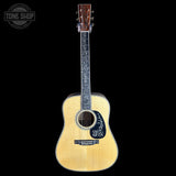 Acoustic guitar with decorative inlay on a black background, featuring 'Tone Shop' logo.