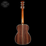 Wooden acoustic guitar on a black background with 'Tone Shop' logo.