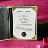 Gibson Custom Certificate of Authenticity on a pink surface