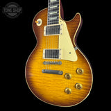 Electric guitar with a sunburst finish on a black background, featuring the Tone Shop logo.