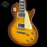 Electric guitar with a sunburst finish on a black background, featuring the Tone Shop logo.
