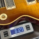 Electric guitar on a digital scale displaying weight