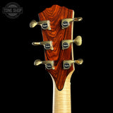 Guitar headstock with Taylor tuning pegs on a black background, featuring the Tone Shop logo.