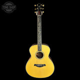 Yellow acoustic guitar on a black background with 'Tone Shop' logo.