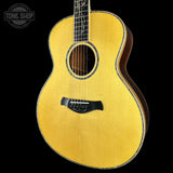 Acoustic guitar with a visible brand logo on a black background