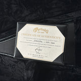 Certificate of Authenticity for a Martin guitar on a black background