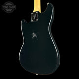 Black electric guitar body with Fender logo on a black background