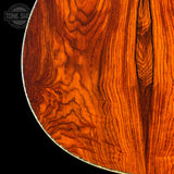 Close-up of a wooden drum head with visible grain and texture.
