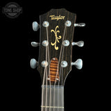 Taylor guitar headstock with brand logo on a black background