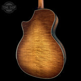 Wooden acoustic guitar body on a black background with 'Tone Shop' logo.