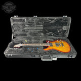 Glossy electric guitar in a hard-shell case with 'Tone Shop' logo.