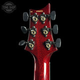 Close-up of a red guitar headstock with tuning pegs on a black background, featuring 'Tone Shop' branding.
