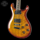 Electric guitar with a sunburst finish on a black background, featuring the Tone Shop logo.