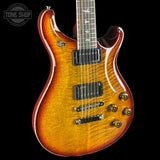 Electric guitar with a sunburst finish on a black background, featuring the Tone Shop logo.