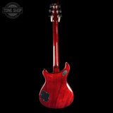Red electric guitar on a black background with 'Tone Shop' logo.