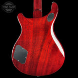 Red electric guitar body with a visible brand logo in the corner.