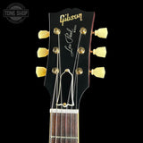 Gibson Les Paul guitar headstock with brand logo on a black background