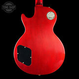 Red electric guitar body with Gibson logo on a black background