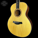 Acoustic guitar with a visible brand logo on a black background
