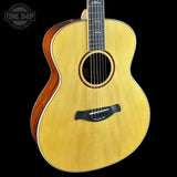 Acoustic guitar with a visible brand logo on a black background
