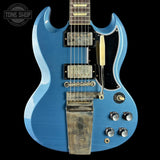 Blue electric guitar with a visible brand logo on a black background