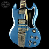 Blue electric guitar with a close-up view on a black background, featuring the 'Tone Shop' logo.