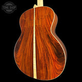 Wooden guitar back with a visible brand logo in the corner