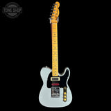 Fender electric guitar with a light blue body on a black background