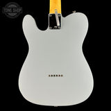 Back view of a silver electric guitar with a black background