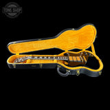 Guitar in an open case with 'Tone Shop' logo in the corner