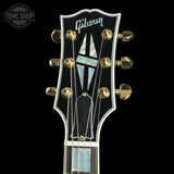 Gibson guitar headstock with brand logo on a black background