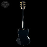 Black electric guitar on a white background with 'Tone Shop' logo.