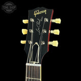 Gibson Les Paul guitar headstock with brand logo on a black background