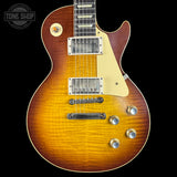 Electric guitar with a sunburst finish on a black background, featuring the Tone Shop logo.