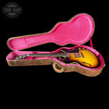 Guitar in a pink case with 'Tone Shop' logo in the corner