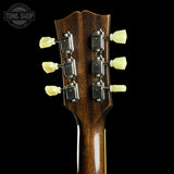 Guitar headstock with tuning pegs on a black background, featuring 'Tone Shop' logo.